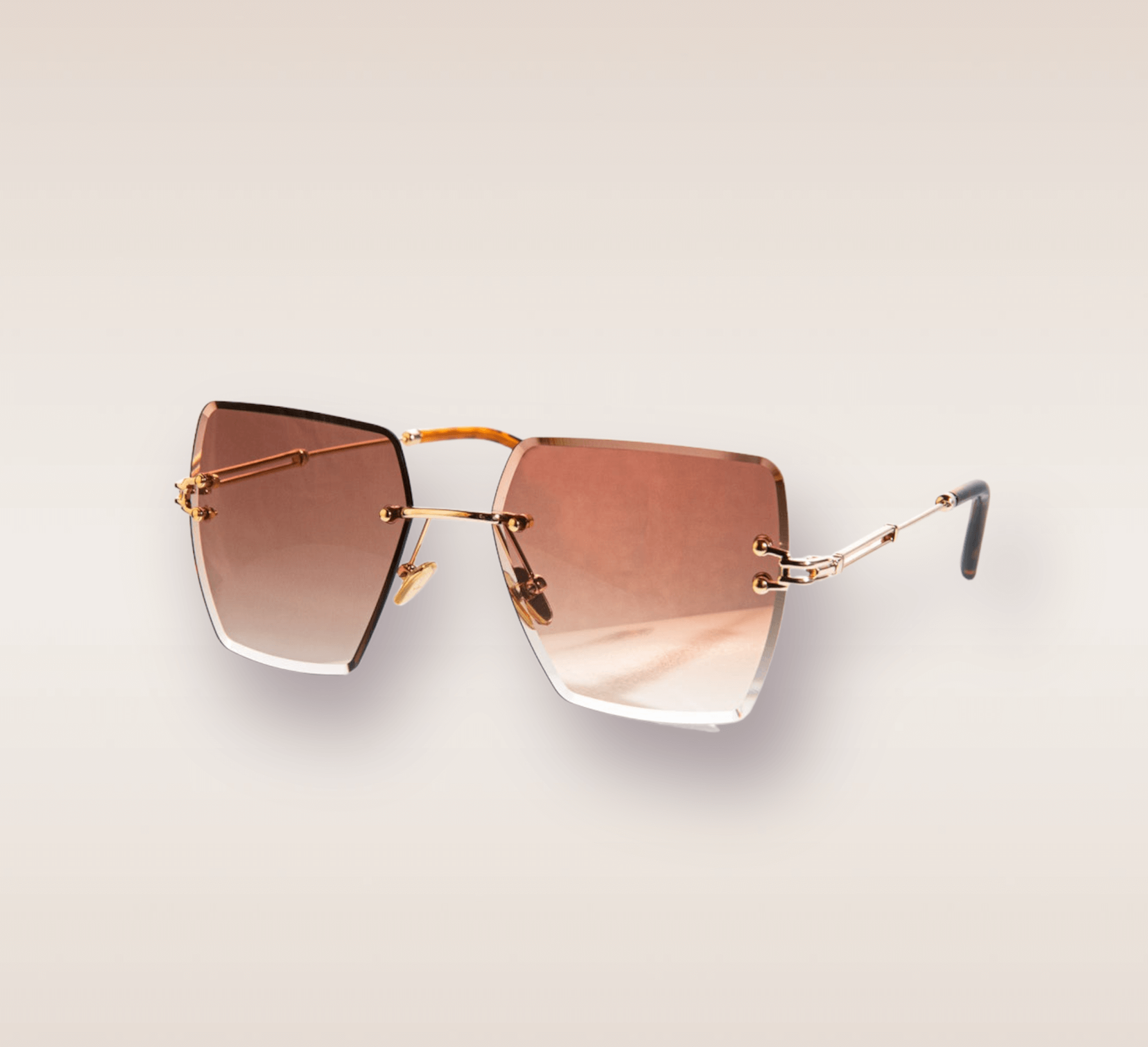 In this up-close shot, we are introduced to the captivating Coco frames, a stylish and sophisticated eyewear option. The rimless frames feature a mesmerizing brown gradient hue. The gold arms add a touch of opulence and refinement, complimenting the brown tones with a warm metallic accent. These frames are a true fashion statement, combining modern design with a touch of luxury. 