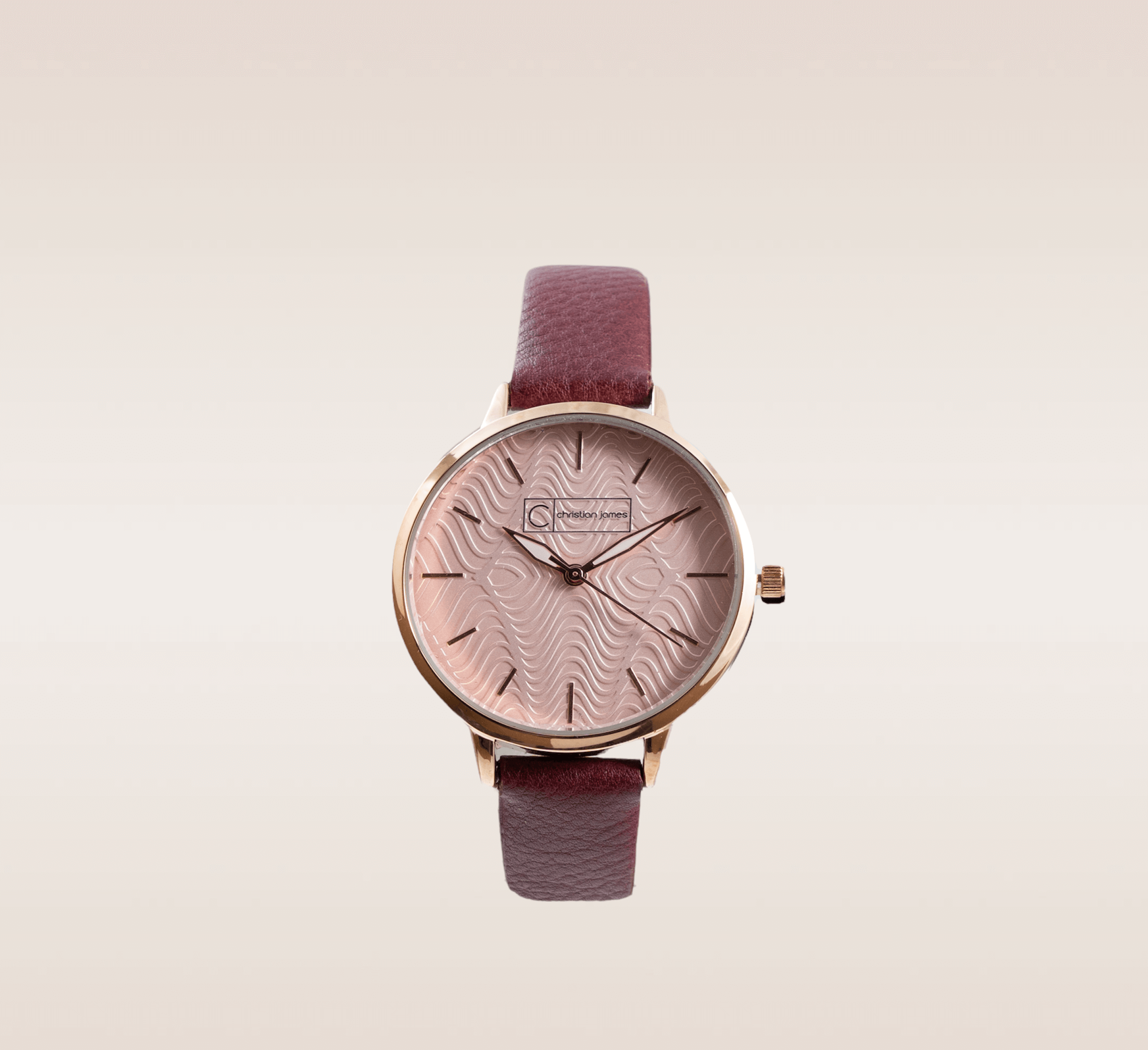 In this up-close shot, we are introduced to the captivating Burgundy Timepiece, a stunning accessory that exudes sophistication and timeless beauty. The watch features a luxurious gold casing that encases its exquisite design. The pink-textured face adds a touch of femininity and uniqueness, with its subtle patterns capturing the light and creating a mesmerizing effect. The watch hands, crafted in elegant gold and white, allows for easy and accurate timekeeping. Enhancing the overall allure, the watch is adorned with a rich burgundy band, exuding a sense of refined elegance.