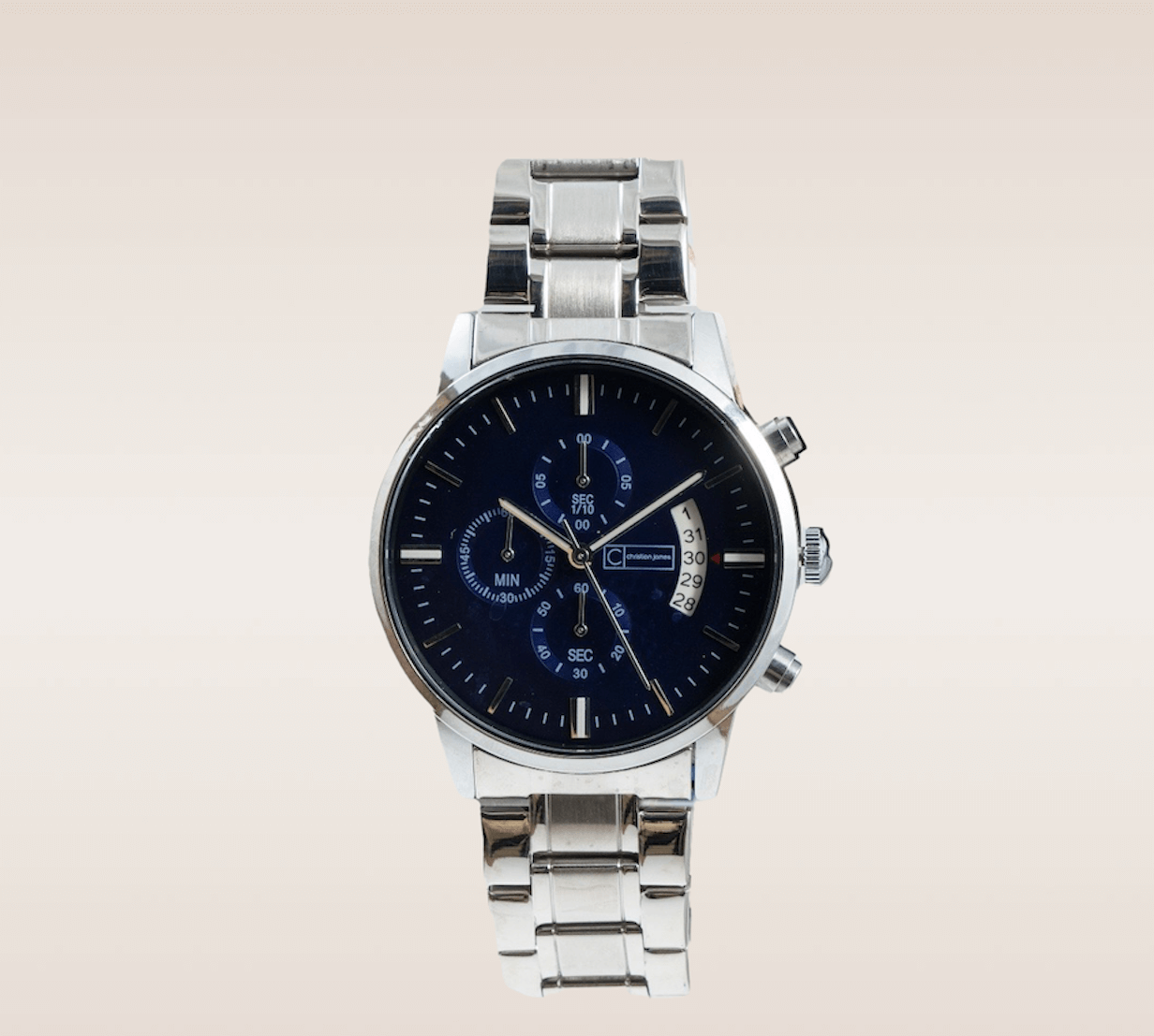 In this up-close shot, we are introduced to the captivating Quicksilver Timepiece, a blend of sleekness and sophistication. The watch boasts a silver link bracelet, exuding a sense of timeless elegance and versatility. Complimenting the silver tones is a deep blue watch face, creating a striking contrast that catches the eye. The face is thoughtfully designed with clear markers, ensuring effortless time reading. The silver and white watch hands gracefully sweep across the face, adding a touch of refinement to the overall design. 