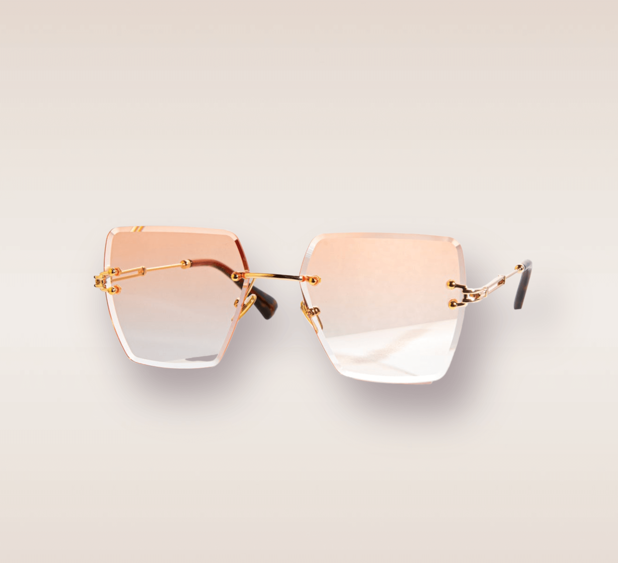 In this up-close shot, we are introduced to the captivating Salmon frames, a stylish and sophisticated eyewear option. The rimless frames feature a mesmerizing peach gradient hue. The gold arms add a touch of opulence and refinement, complimenting the peach tones with a warm metallic accent. These frames are a true fashion statement, combining modern design with a touch of luxury. 