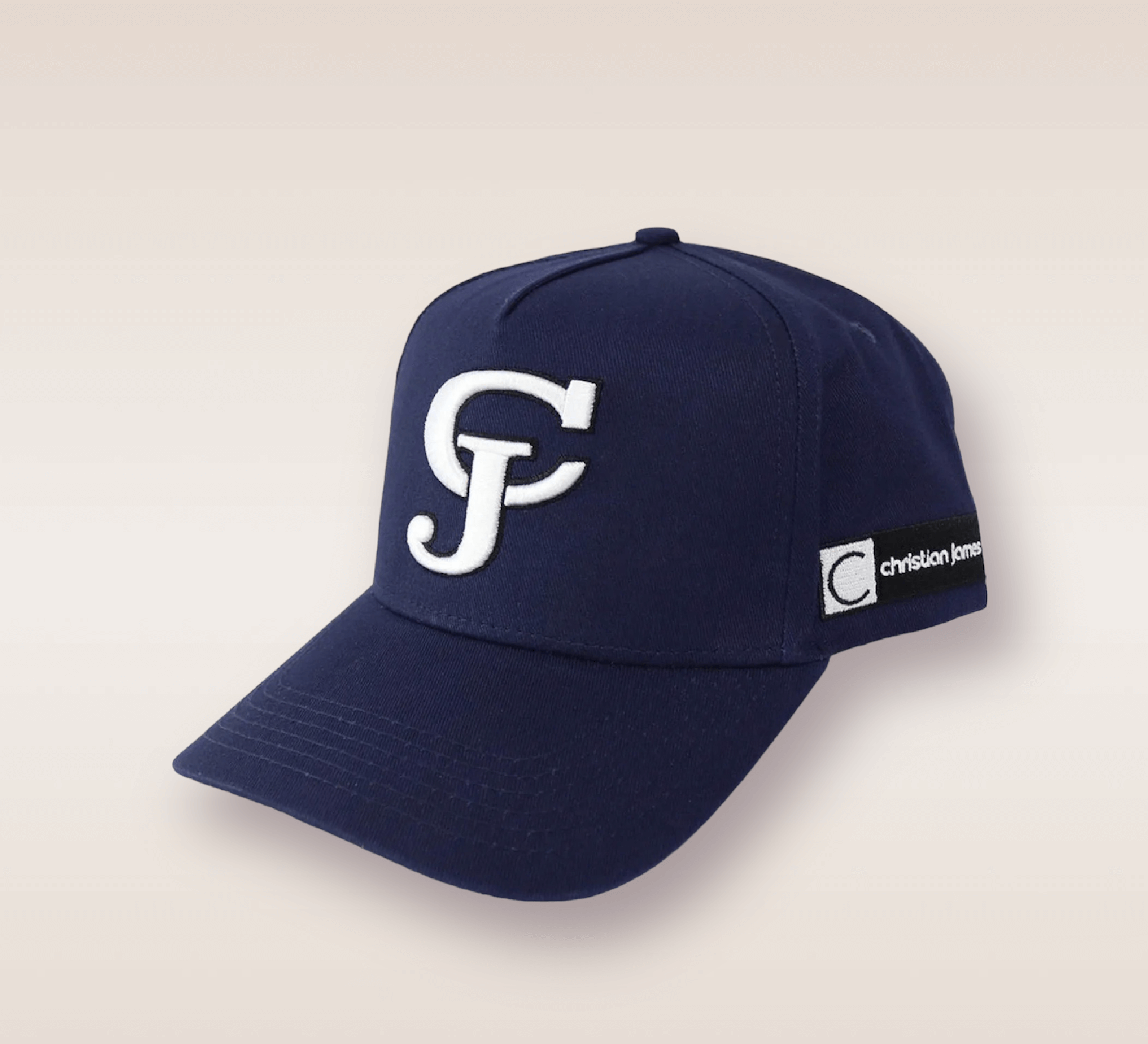 In this up-close shot, we are introduced to the Navy Blue CJ Snapback. The hat features a deep navy blue color that exudes a sense of sophistication and versatility. Embroidered in white lettering is the brand’s acronym 